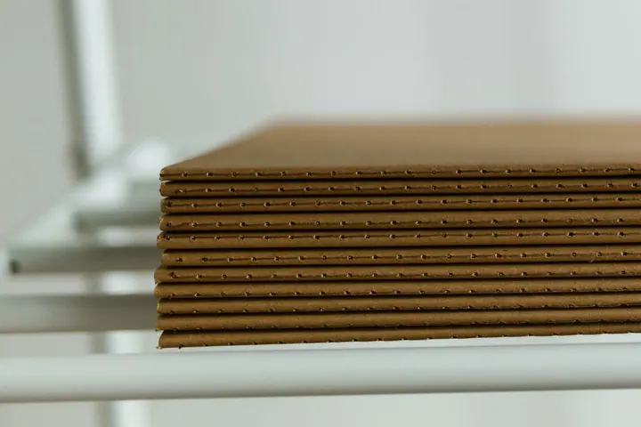 Stacked corrugated cardboard sheets on a shelf